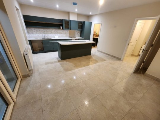 Modern kitchen with floor tiling and marble wall design by RCTiling Dublin.