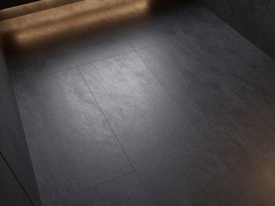 Modern large-format charcoal floor tiles in a Dublin bathroom featuring warm under-cabinet LED lighting and integrated underfloor heating.