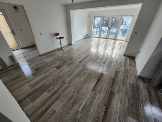 Large open-plan Dublin home with glossy wood-effect porcelain floor tiles installed by RCTiling Dublin