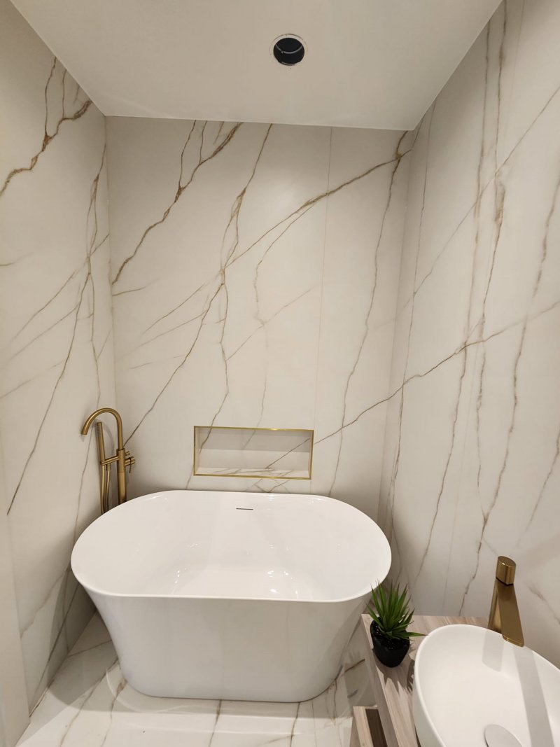 Elegant bathroom with freestanding tub and gold accents