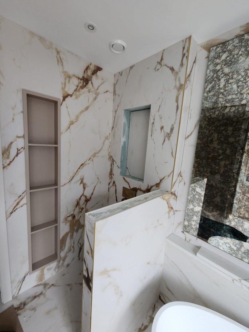 Marble bathroom with double vanity and glass shower partition by RC Tiling Dublin