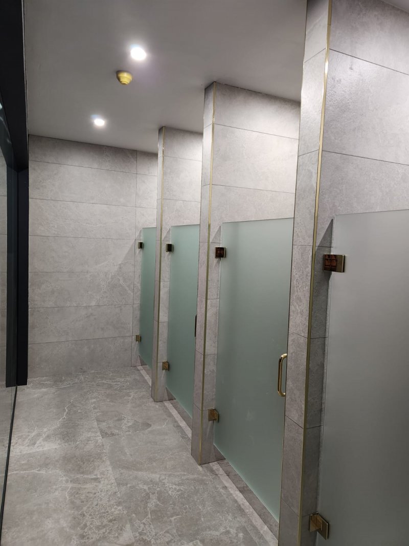 Four shower cabins with frosted glass doors – left-front view, large tile installation by RC Tiling Dublin