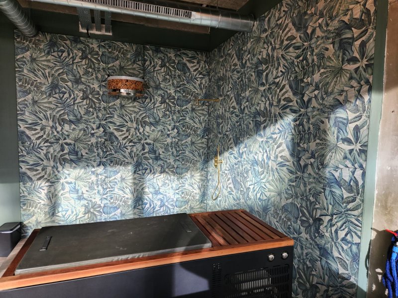 Close-up of ceramic wall tiles with green and white botanical pattern – RC Tiling Dublin