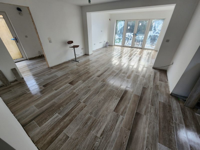 Parquet flooring extending toward adjacent room in open-plan layout