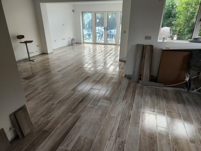 Panoramic view of open-plan space with continuous wood-effect porcelain flooring