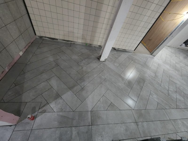 Wide view of room with herringbone stone tile flooring – RC Tiling Dublin  