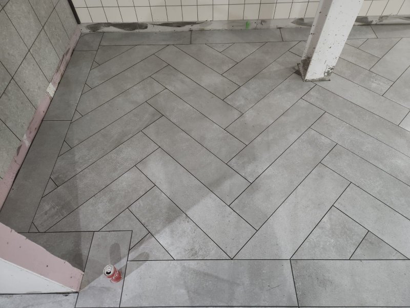 Close-up of herringbone stone tile alignment in renovated room – RC Tiling Dublin