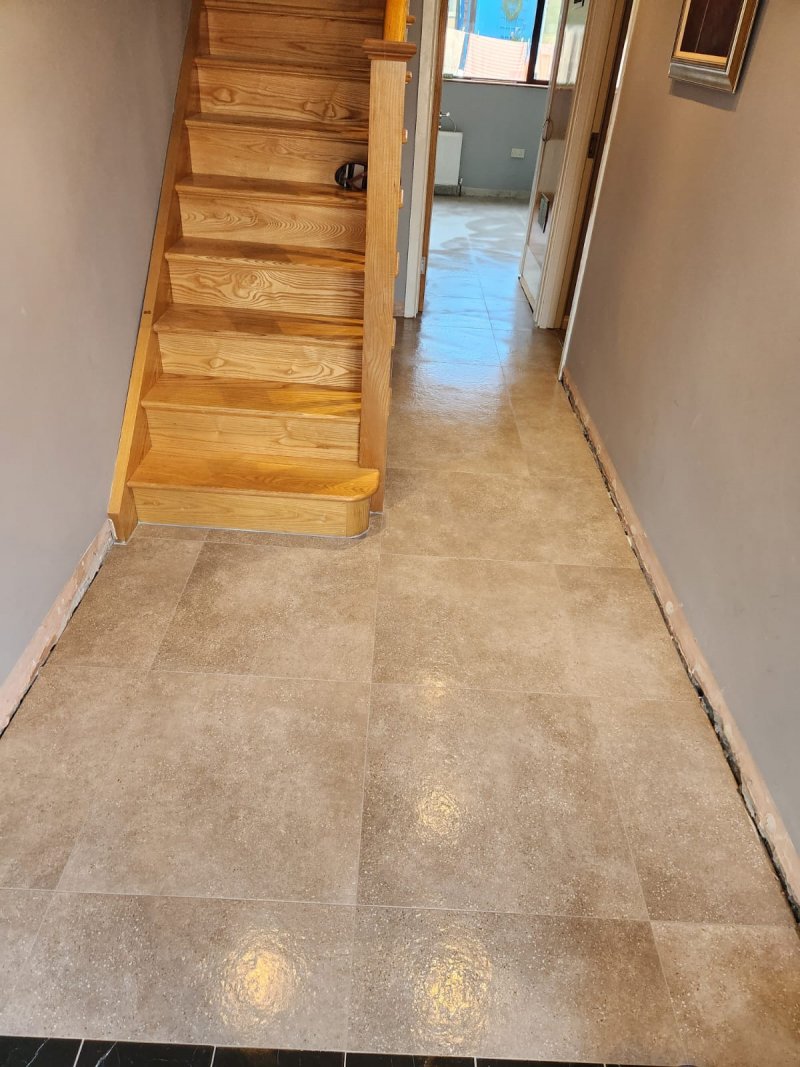 Ceramic tile flooring near wooden staircase with precise alignment – RC Tiling Dublin