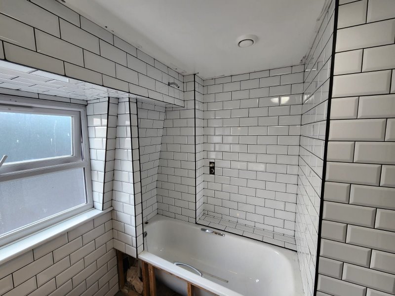 Bathroom under renovation with white ceramic tiles and countertop cutout – RC Tiling Dublin