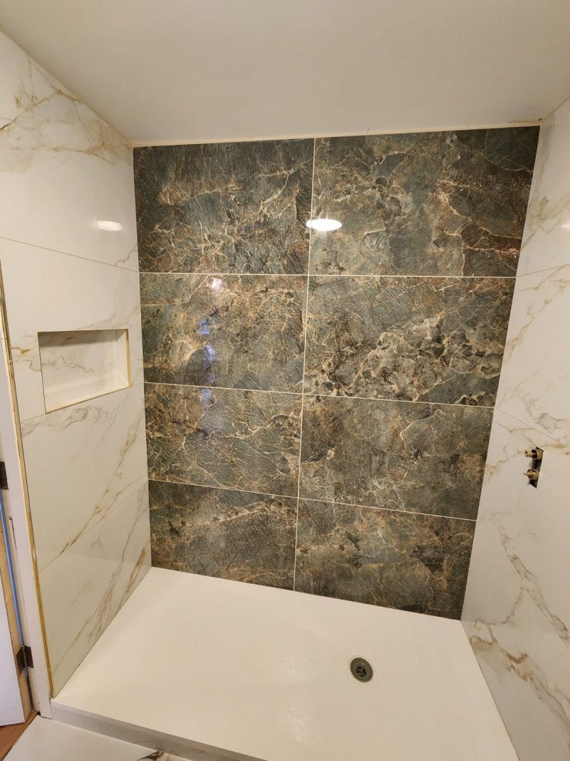 Shower area with green marble wall and white marble tiles with green and gold veining – RC Tiling Dublin