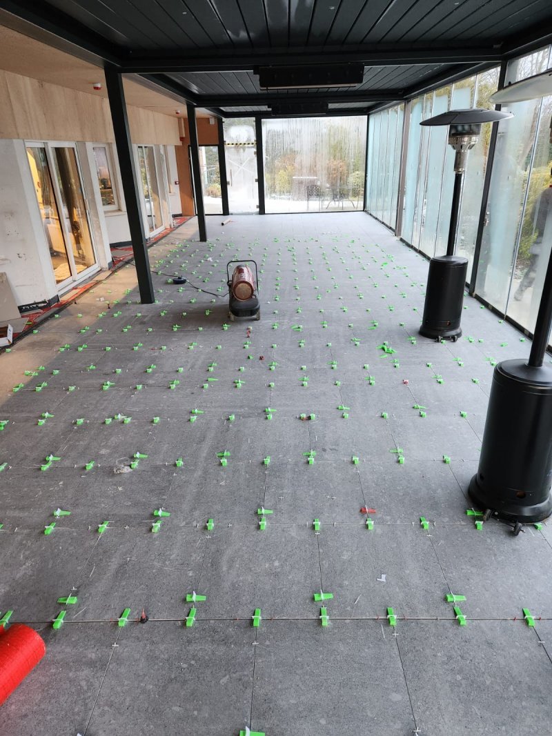 Covered terrace with large-format ceramic tiles being installed – RC Tiling Dublin
