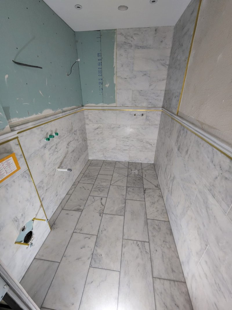 Shower room renovation with large-format ceramic tiles and visible installation tools – RC Tiling Dublin