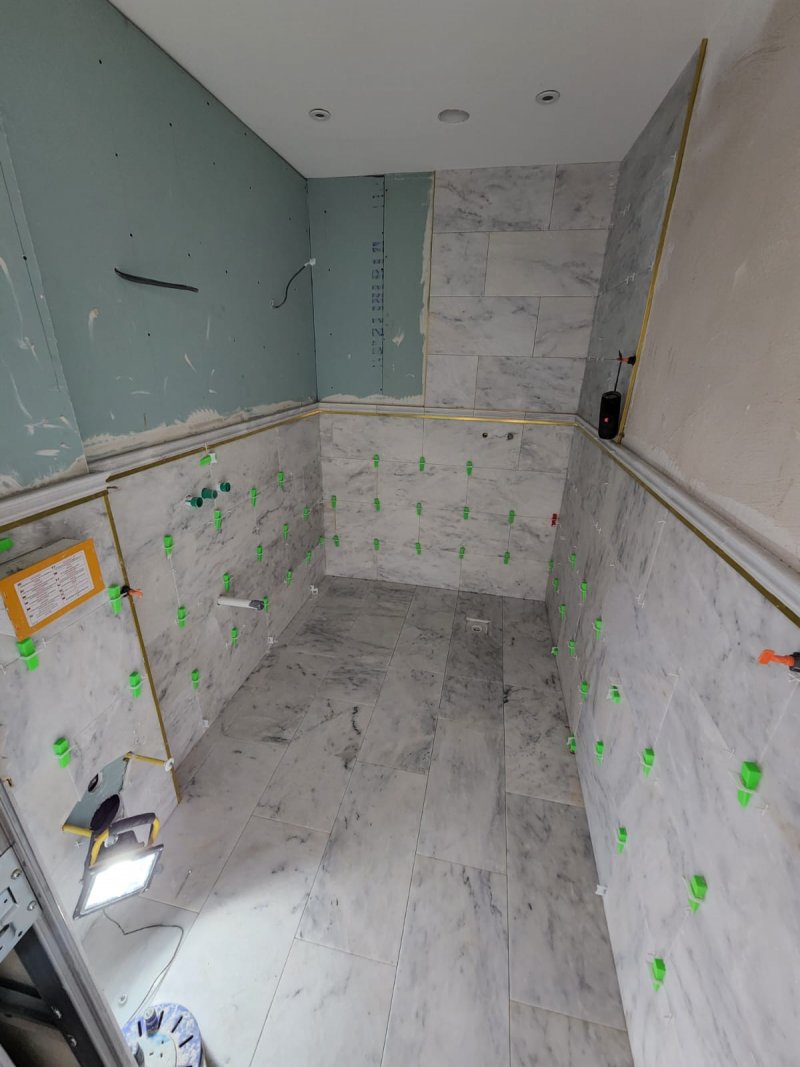 Bathroom under renovation with large-format marble-look tiles on floor and walls – RC Tiling Dublin