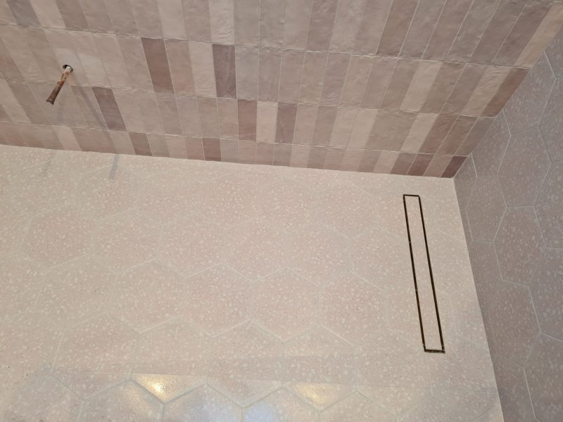 Close-up of mosaic tilework on shower floor with linear drain – RC Tiling Dublin