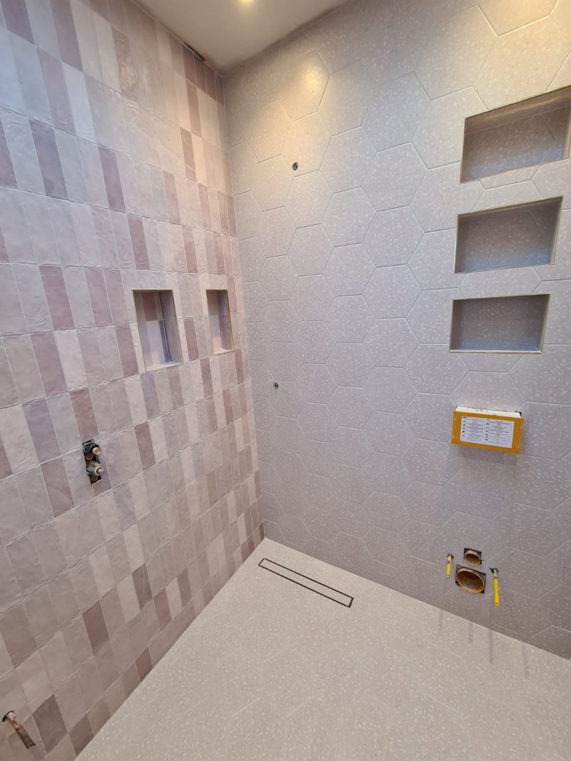 Bathroom with large hexagonal tiles and small-format mosaic in shower area – RC Tiling Dublin