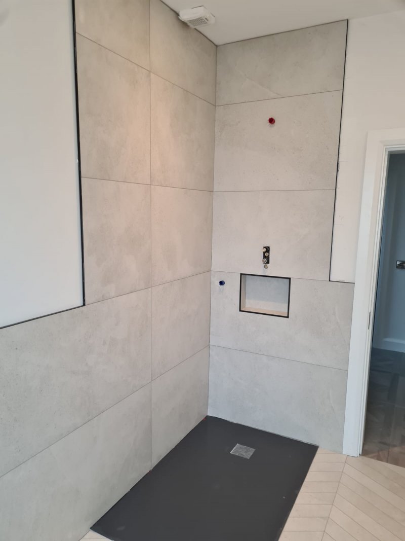 Bathroom wall with large-format concrete-effect tiles and recessed niche – RC Tiling Dublin