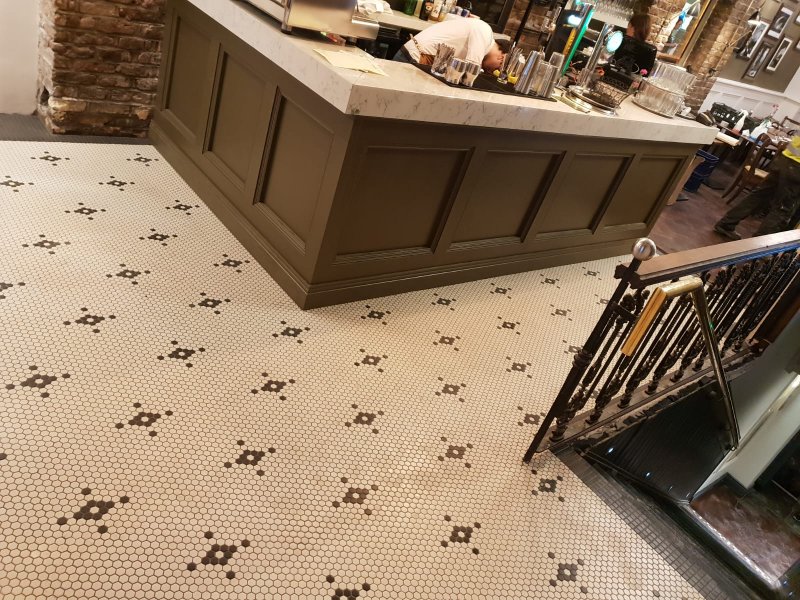 Restaurant interior with hexagonal tile floor and marble counter – RC Tiling Dublin