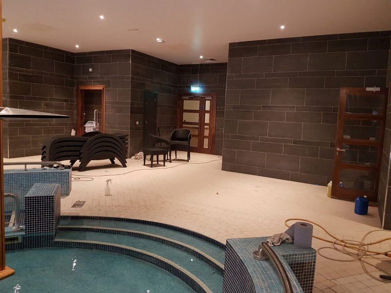 Large format dark grey wall tiles and non-slip floor tiling for a Dublin spa.