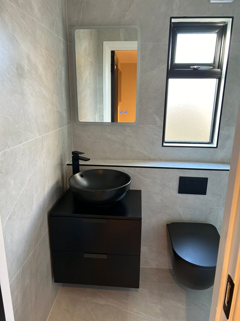 Modern bathroom vanity and wall-hung toilet with grey marble tiling by RCTiling Dublin.